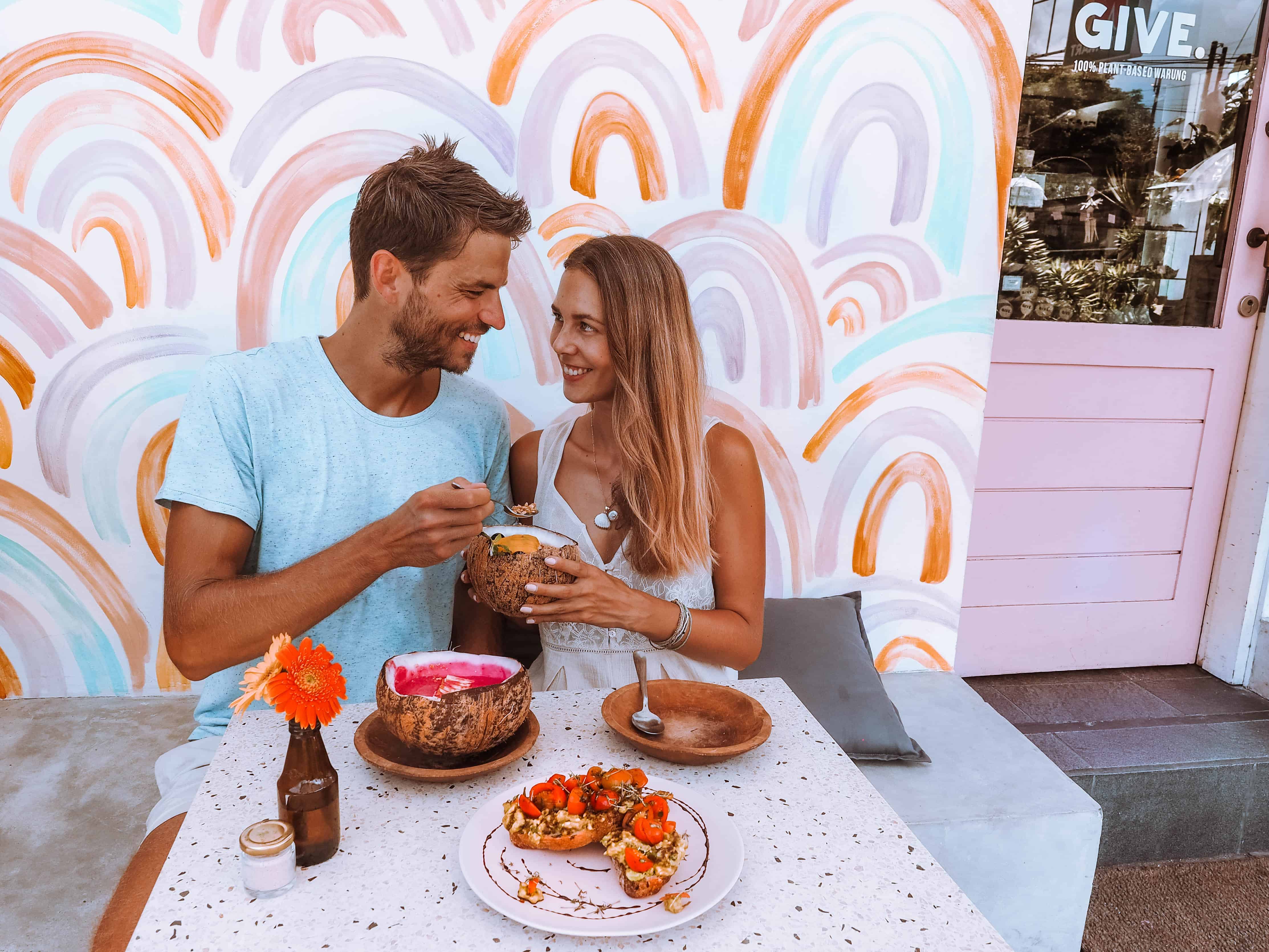 couple eating smoothie bowls at give cafe canggu bali