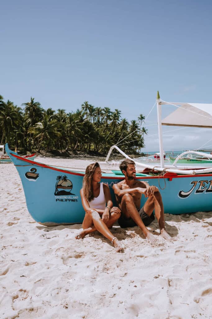Siargao Daku Island Beach Boat Couple Sitting