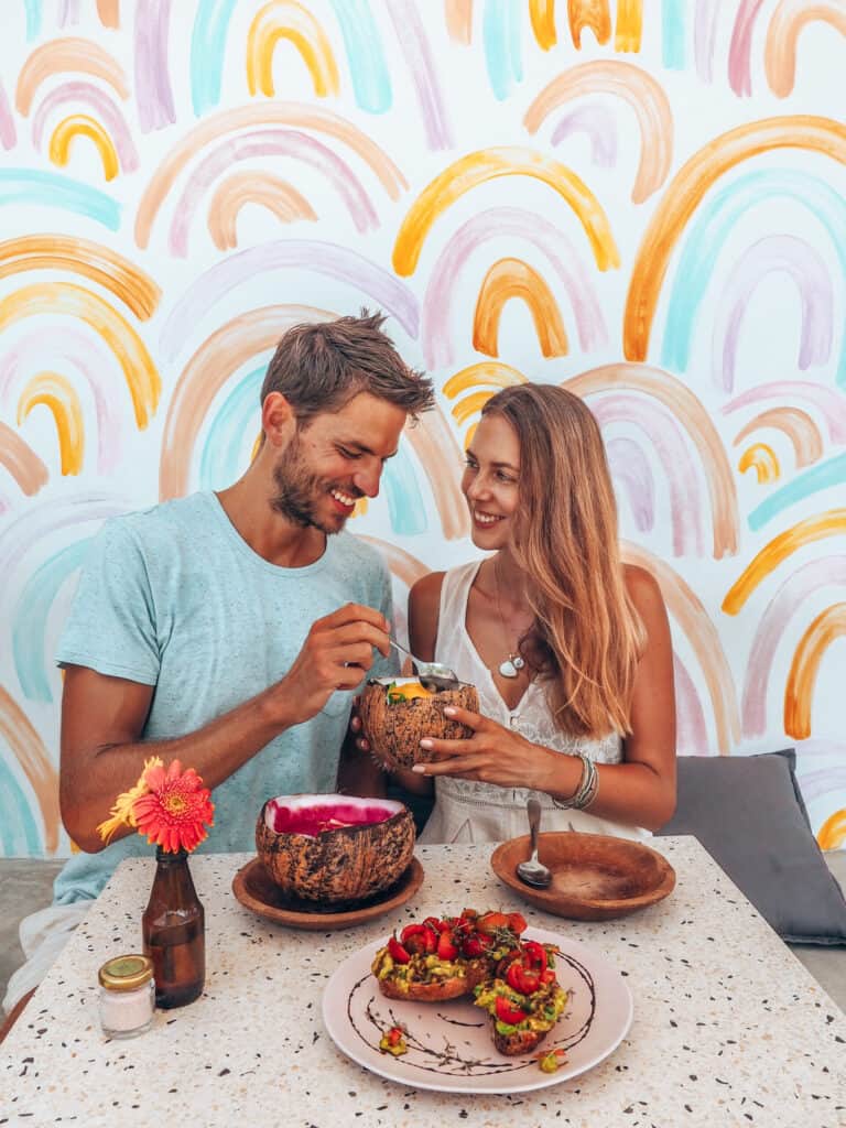 Couple eating smoothie bowls at give cafe canggu bali