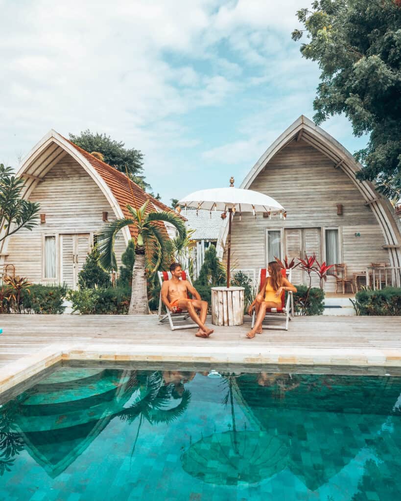 Couple chilling at pool at la roja Bungalows Nusa Penida