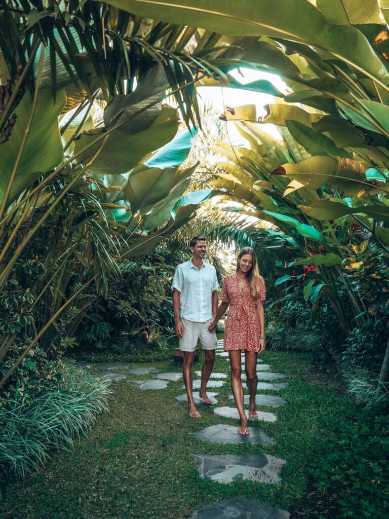 Couple walking in the garden of adiwana arya villa