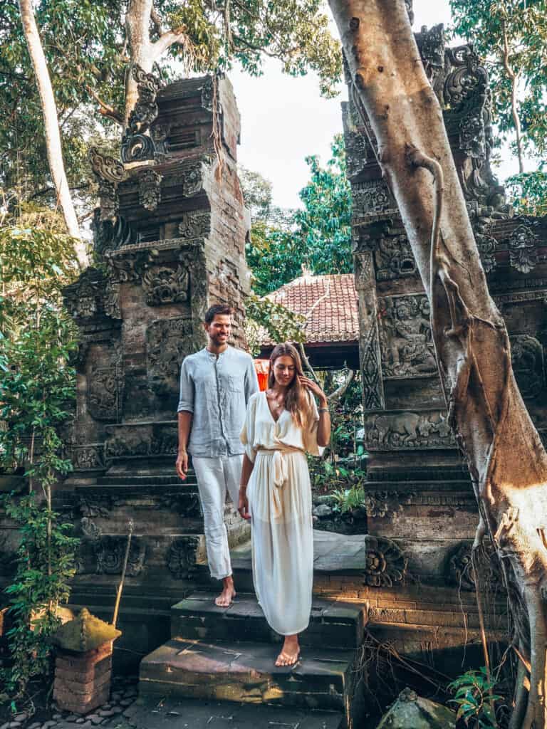 Couple walking through gate at adiwana svarga loka hotel