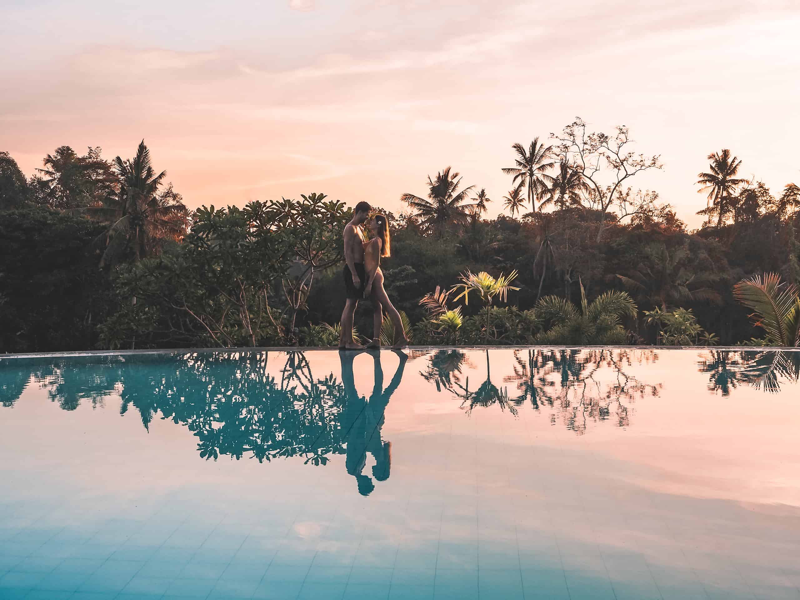 Couple on the pool at sunset at amatara royal ganesha hotel