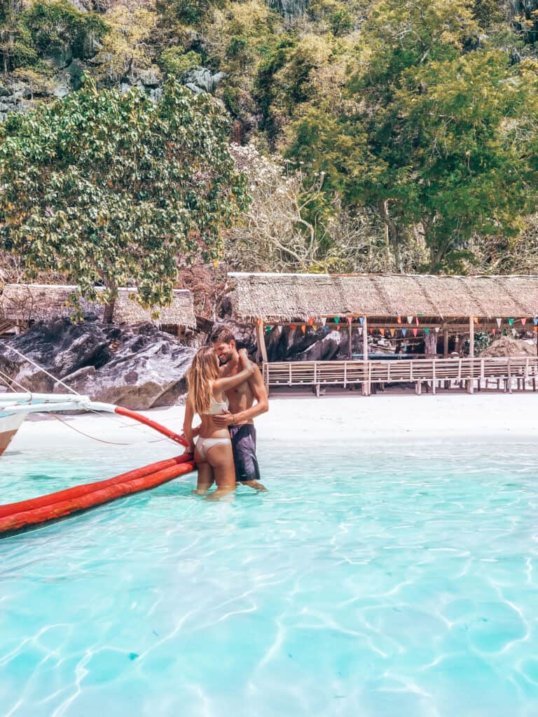 Couple standing in water at Banul Beach Coron Philippines