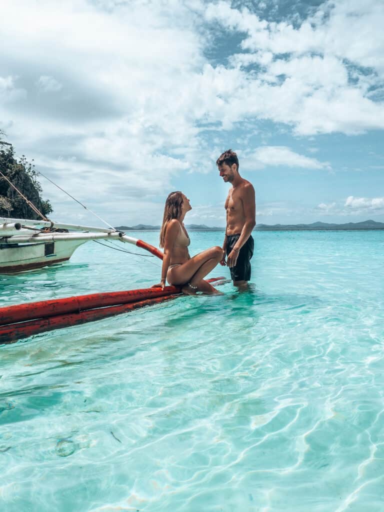 Couple standing in water at Banul Beach