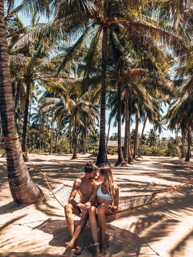 Couple sitting in Hammock at Duli Beach El Nido Philippines