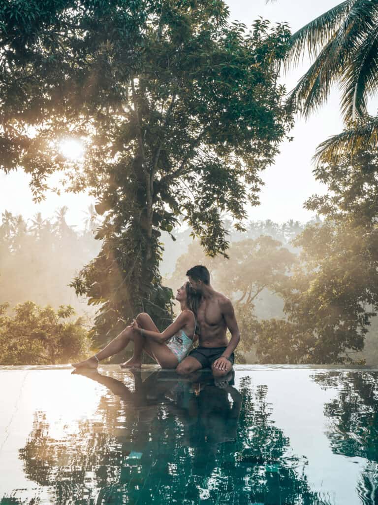 Couple sitting in Pool at sunset at Kamandalu Resort Ubud