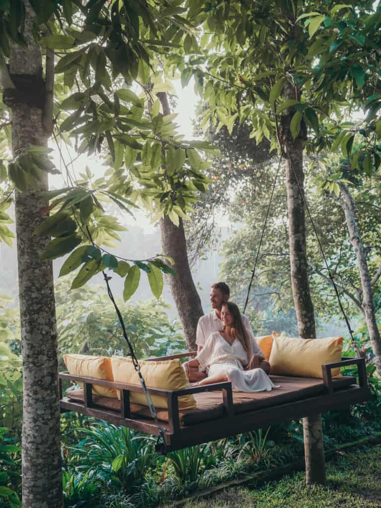 Couple sitting in Swing at Kamandalu Resort Ubud Bali