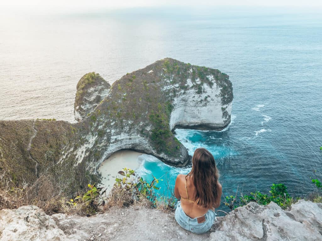 Women sitting on the cliff of Kelinking Beach Nusa Penida