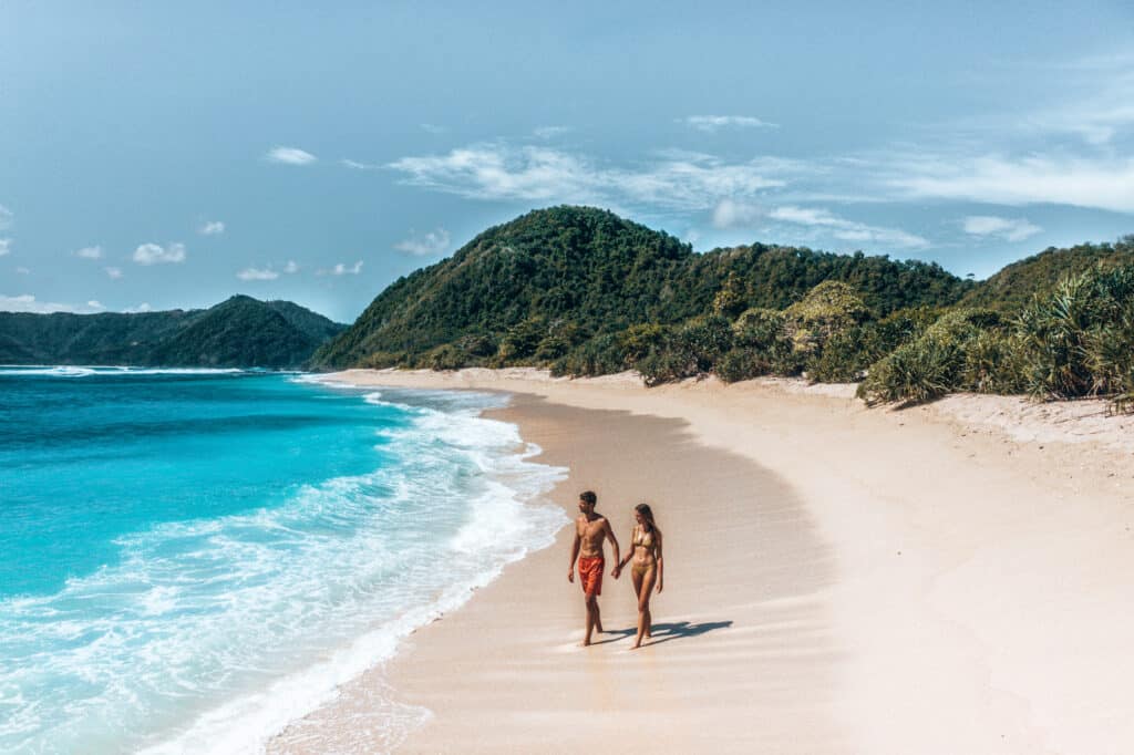 Drone shot of couple walking on Mawi Beach Lombok