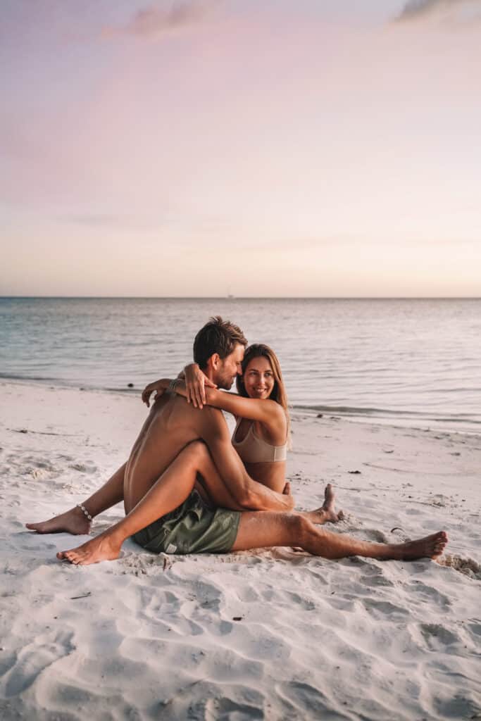 Couple sitting at the beach on Siquijor Island on Sunset