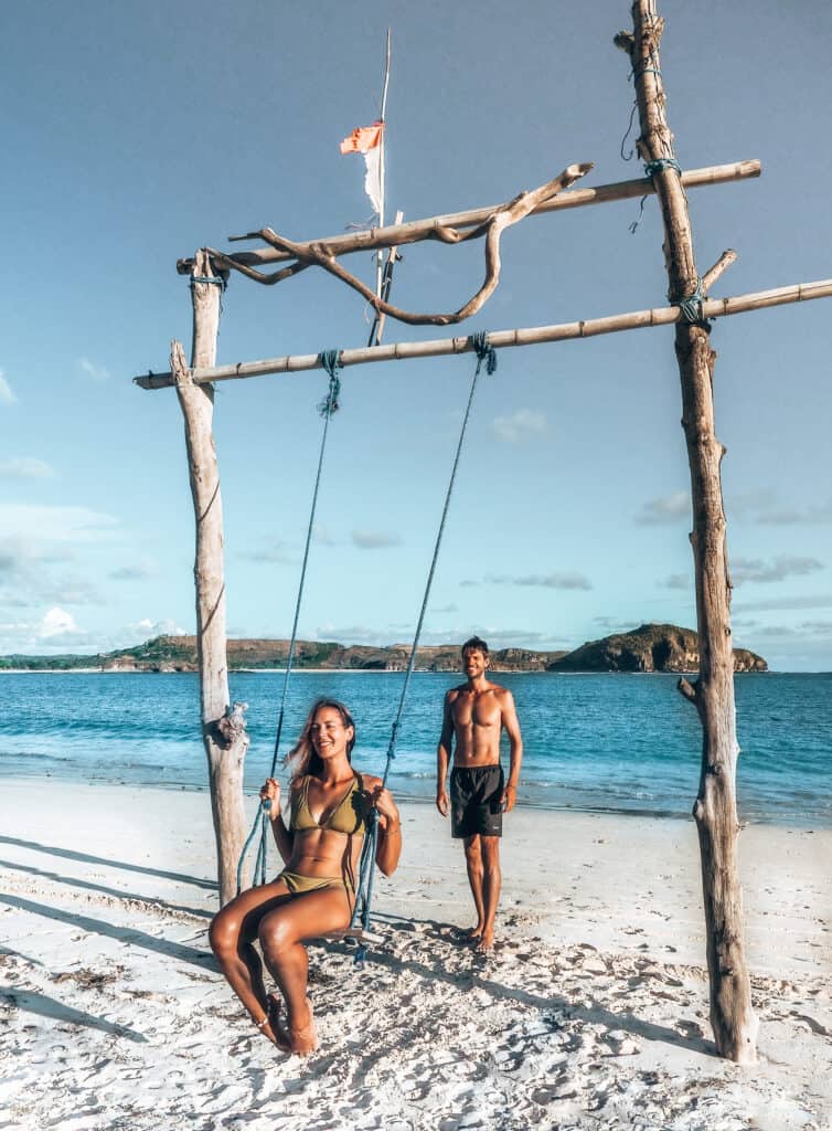 Couple on swing at Tanjung Aan Beach Lombok