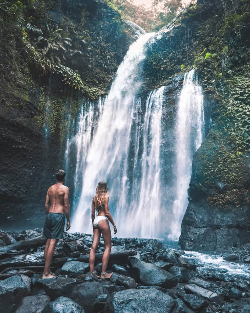 Couple in front of Tiu Kelep Waterfall Lombok
