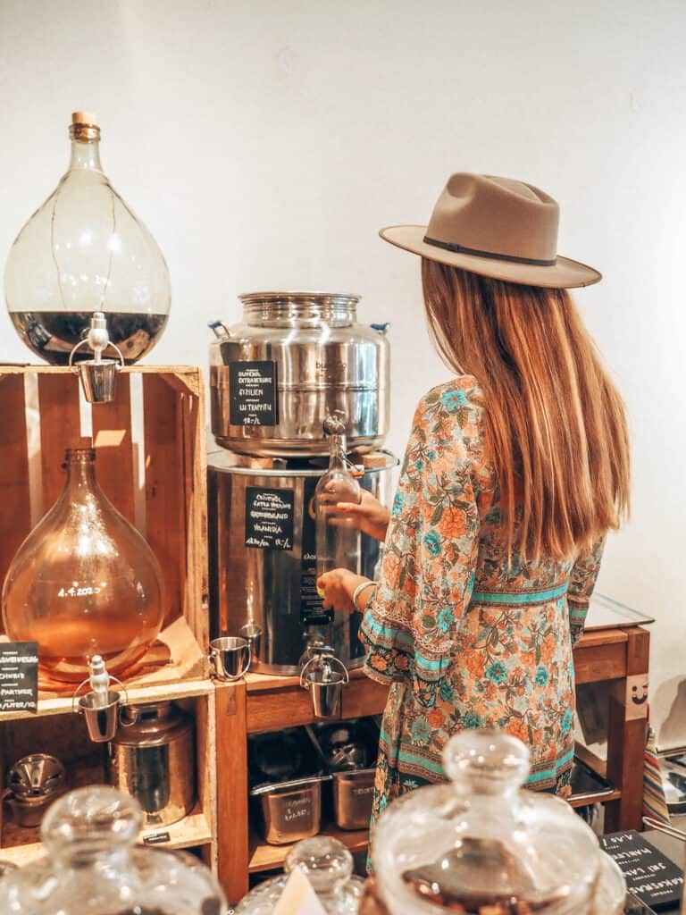 Woman filling a bottle of glas with oil