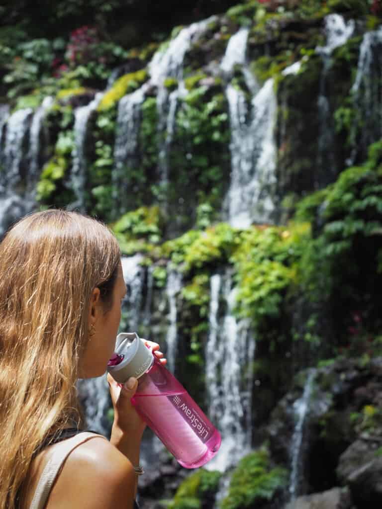 Woman sipping from a LifeStraw Water Bottle