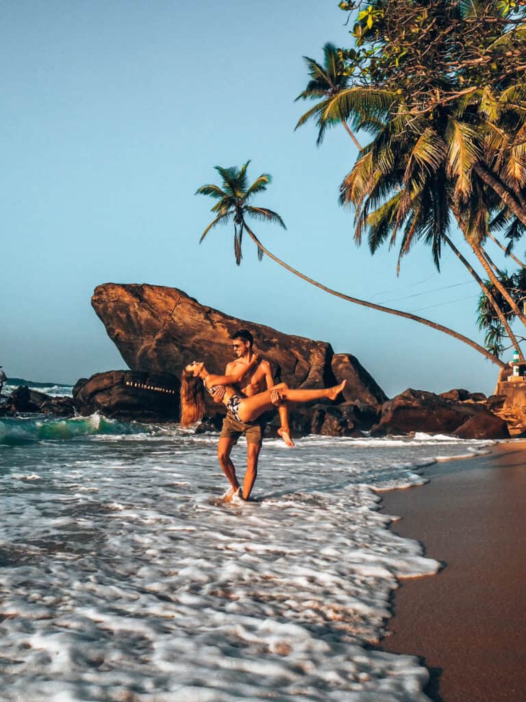 Dalawella Beach Man carries women in hands