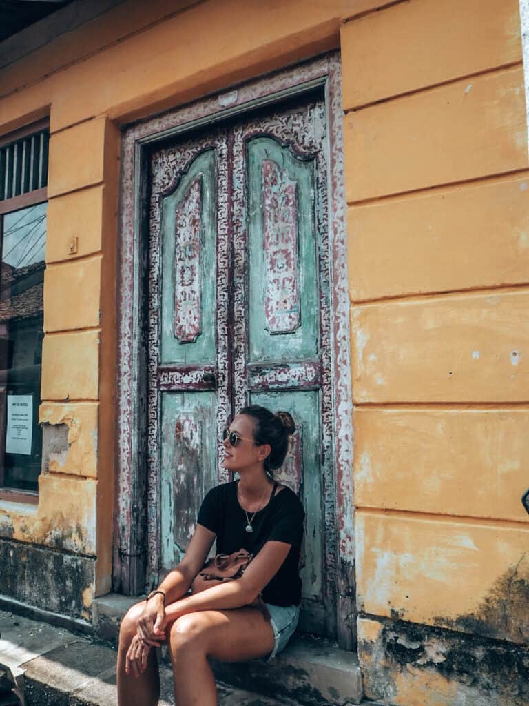 Galle Fort Women sitting in front of wooden door