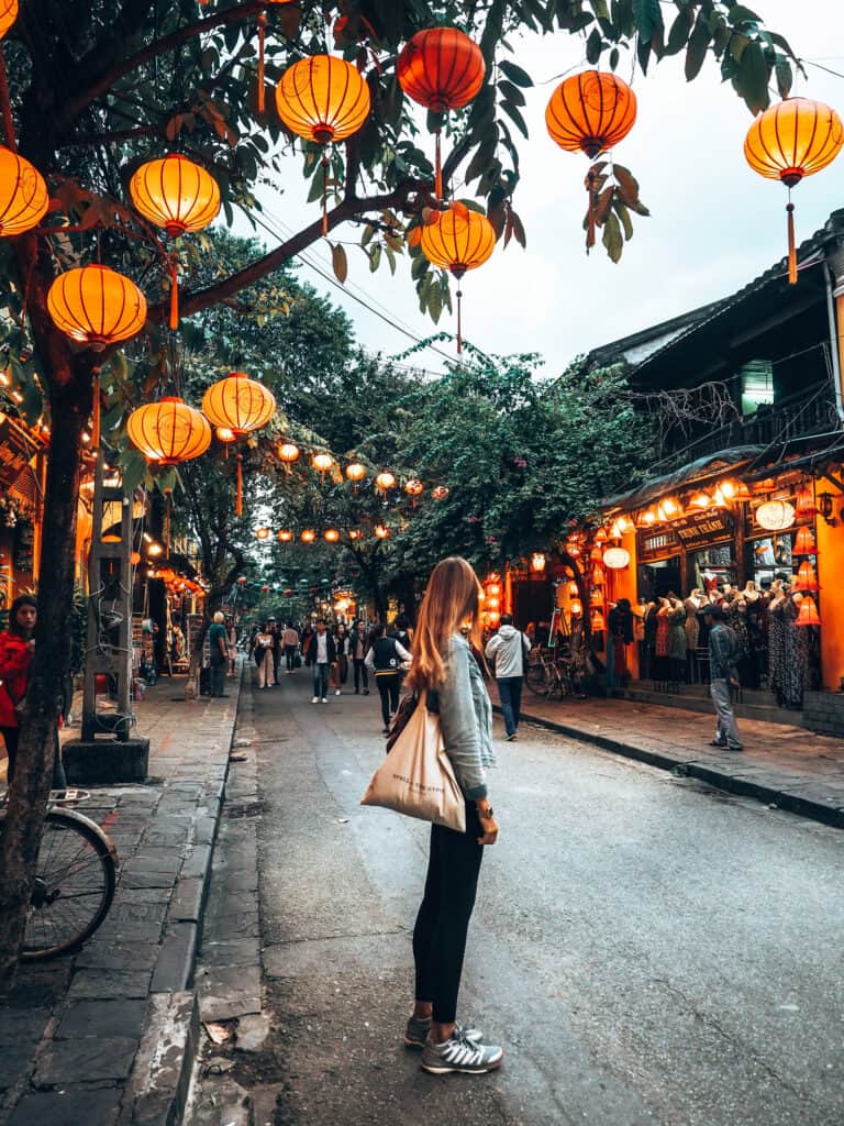 Hoi An Women beneath lanterns in street