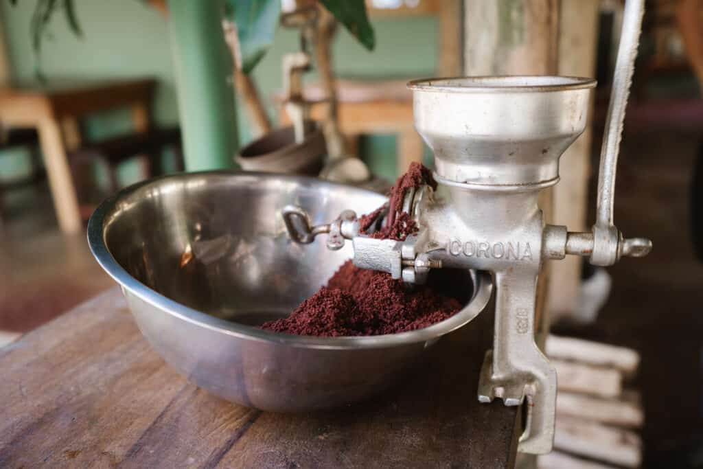 Grounding roasted cacao beans into cacao powder