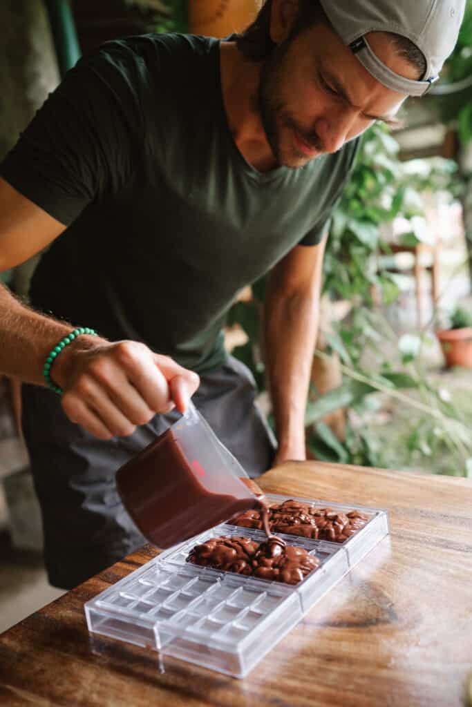 Man pouring liquid chocolate into a mold
