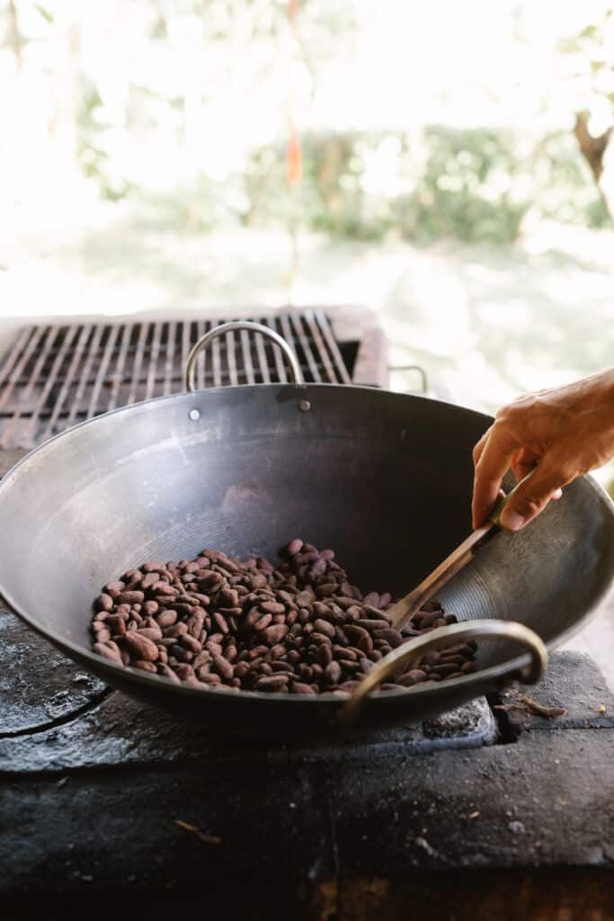 Roasting Cacao Beans in pan over wood fire
