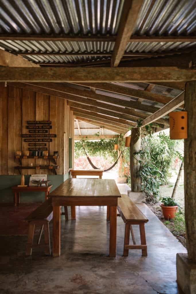 A wooden table in a wooden house with a hammock located in La Fortuna, Costa Rica.