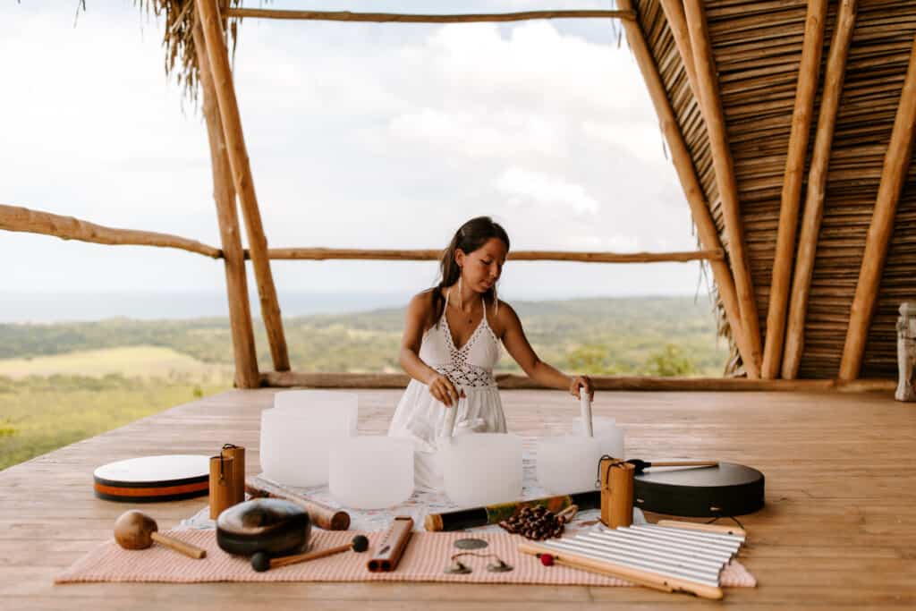 A woman is sitting on top of a wooden deck in Nosara Costa Rica.