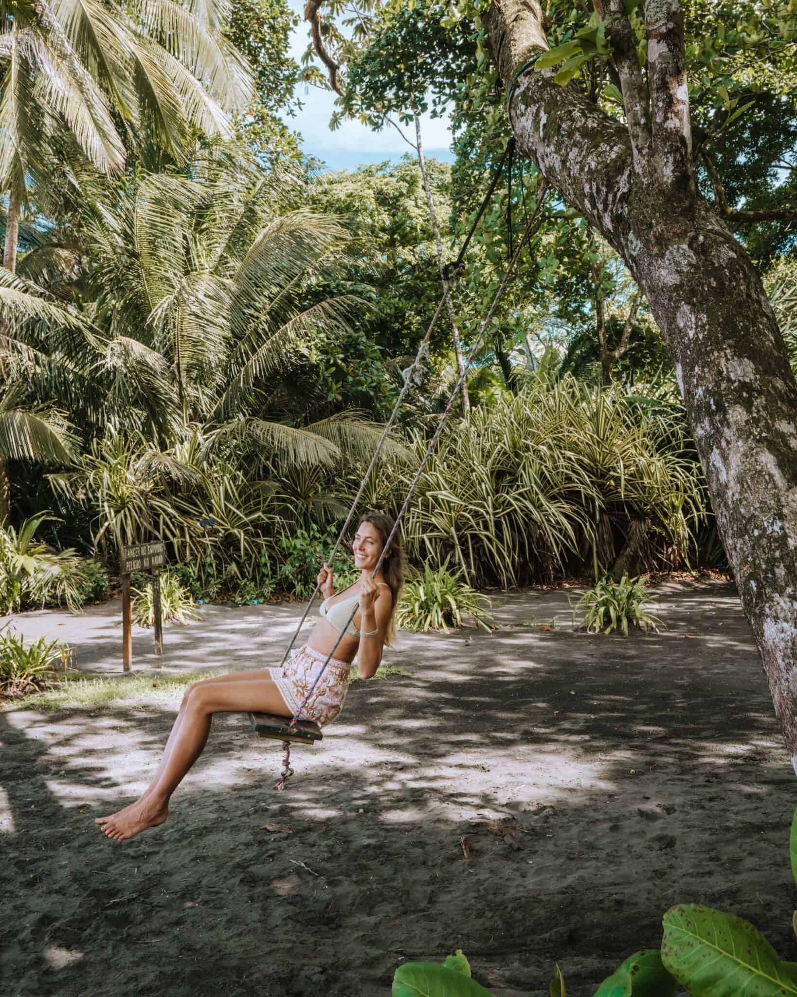 A woman swinging on a swing in Tortuguero, Costa Rica.