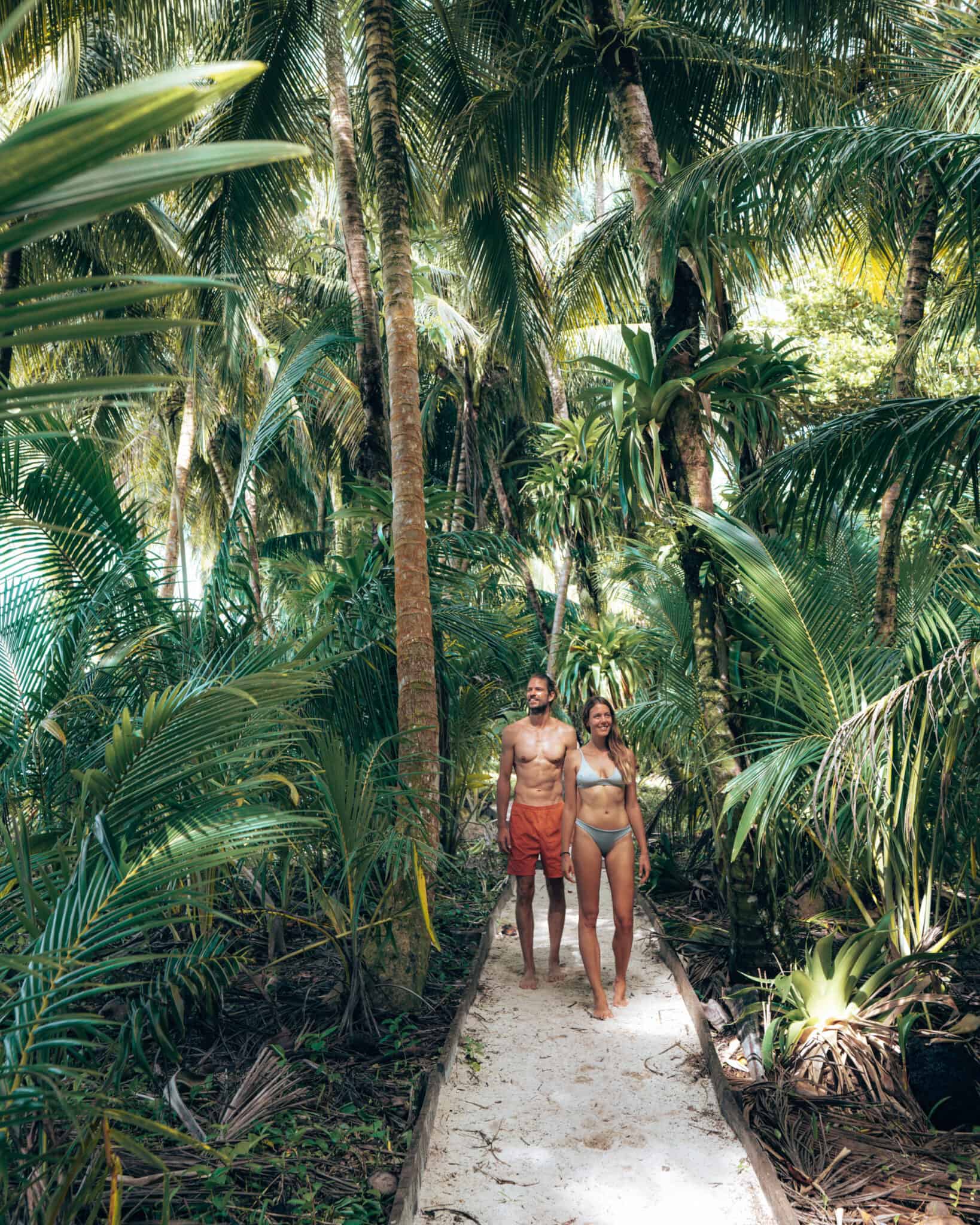 Two people navigating through the dense vegetation in Bocas del Toro.