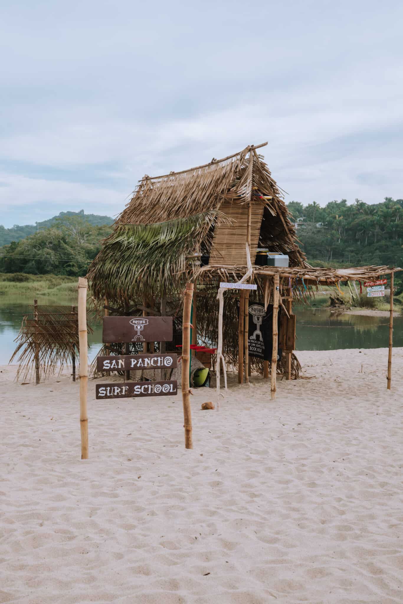 A Sayulita beach hut with a sign on it.