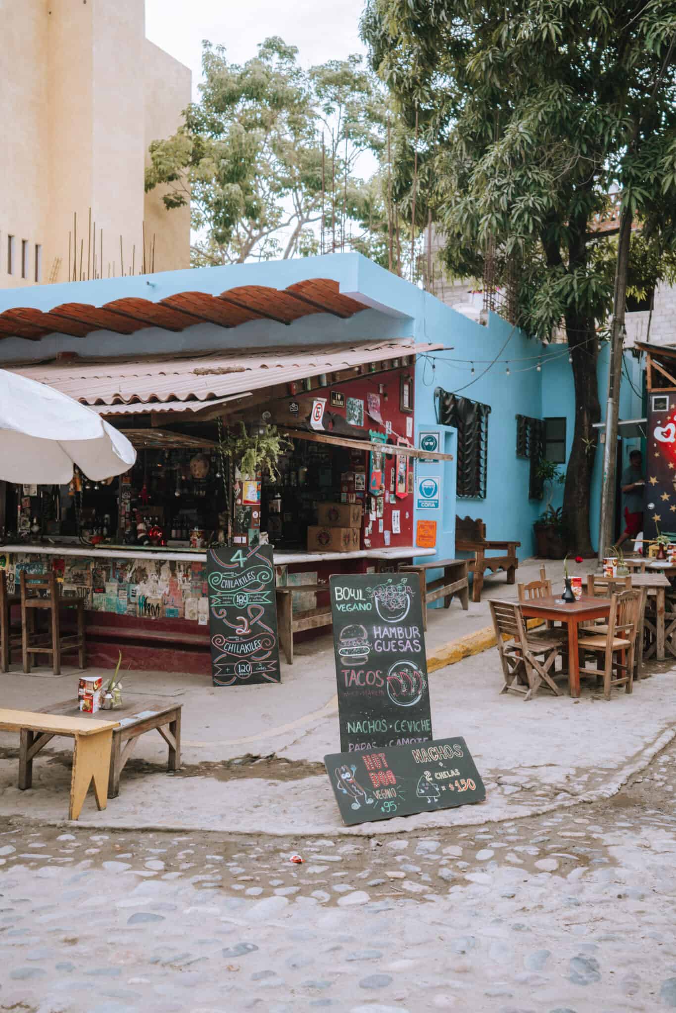 A Sayulita restaurant with tables and chairs on a cobblestone street.