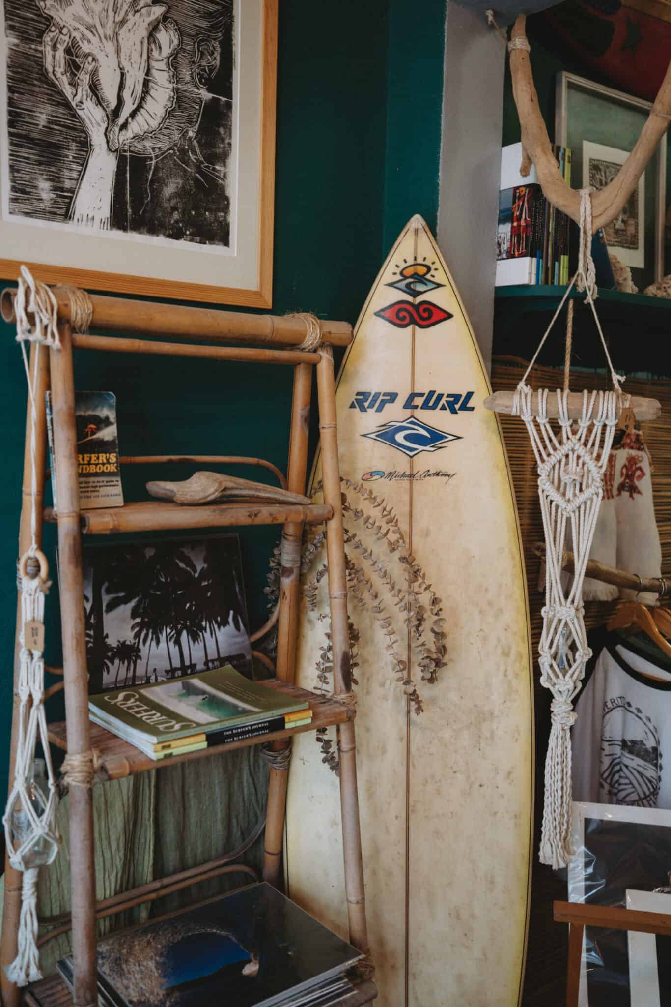 A surfboard is sitting on a shelf in a Sayulita room.