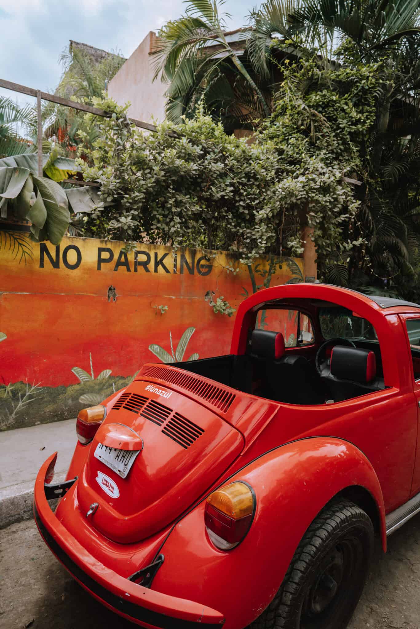 A red Volkswagen Beetle parked in Sayulita.