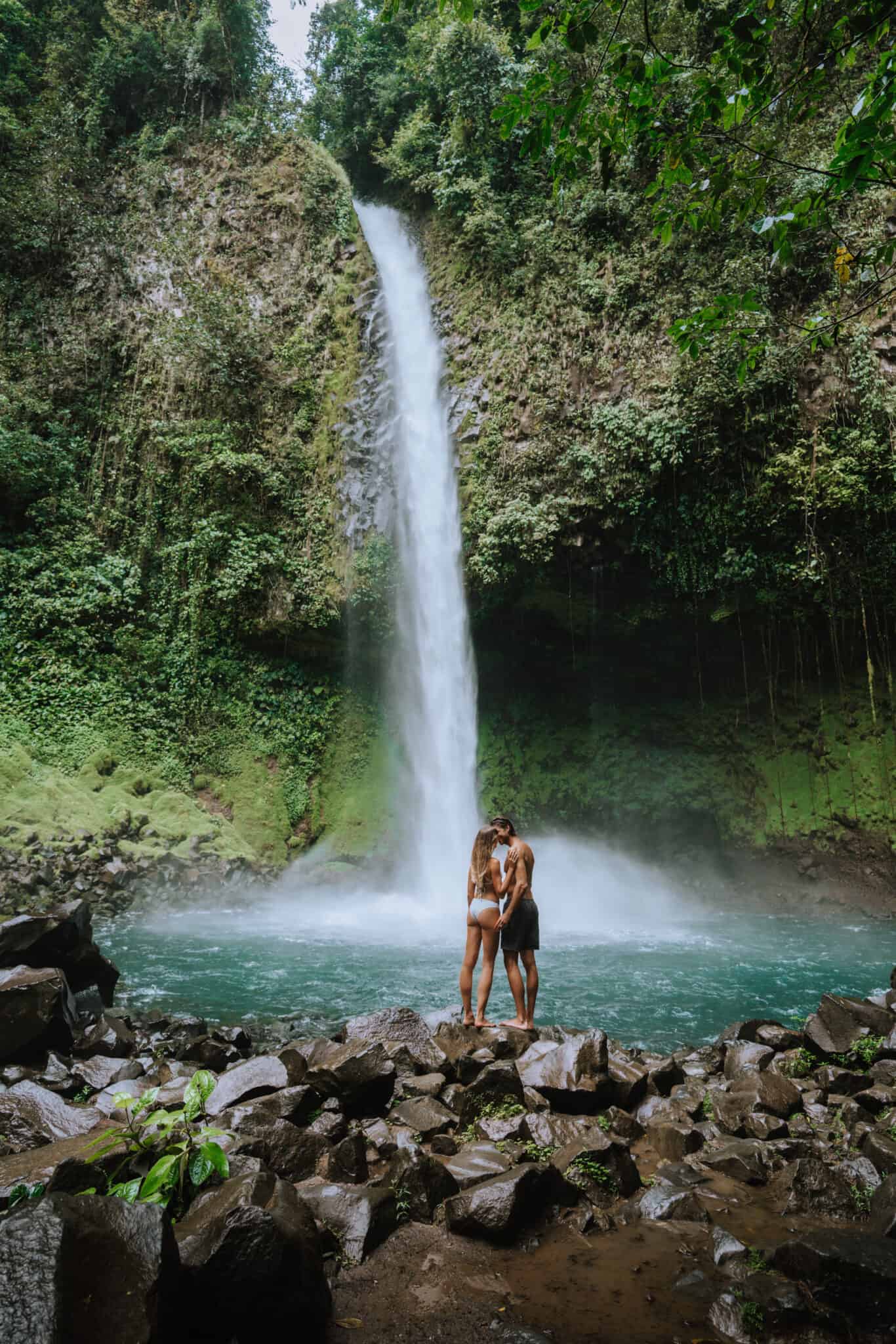 A couple admiring a waterfall in Costa Rica.