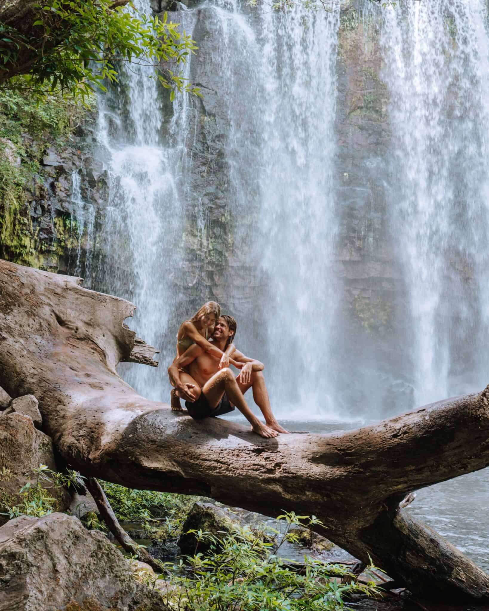 A couple enjoying a waterfall in Costa Rica.