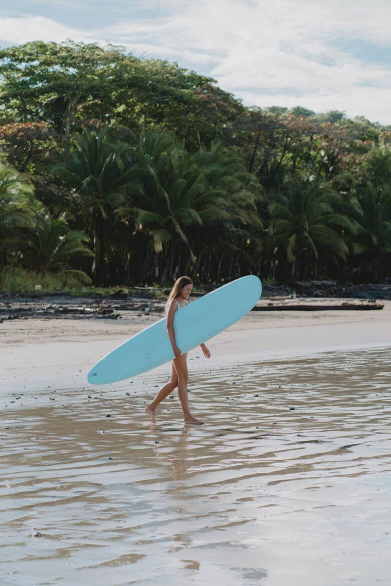 Playa Hermosa Santa Teresa Woman Carry Surfboard from cheboards