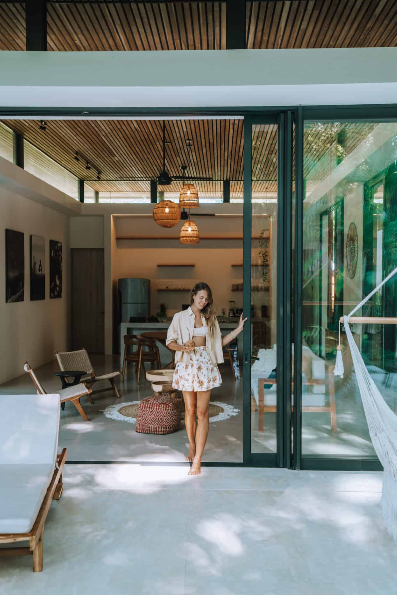 A woman standing in front of a house, ready to work with us.