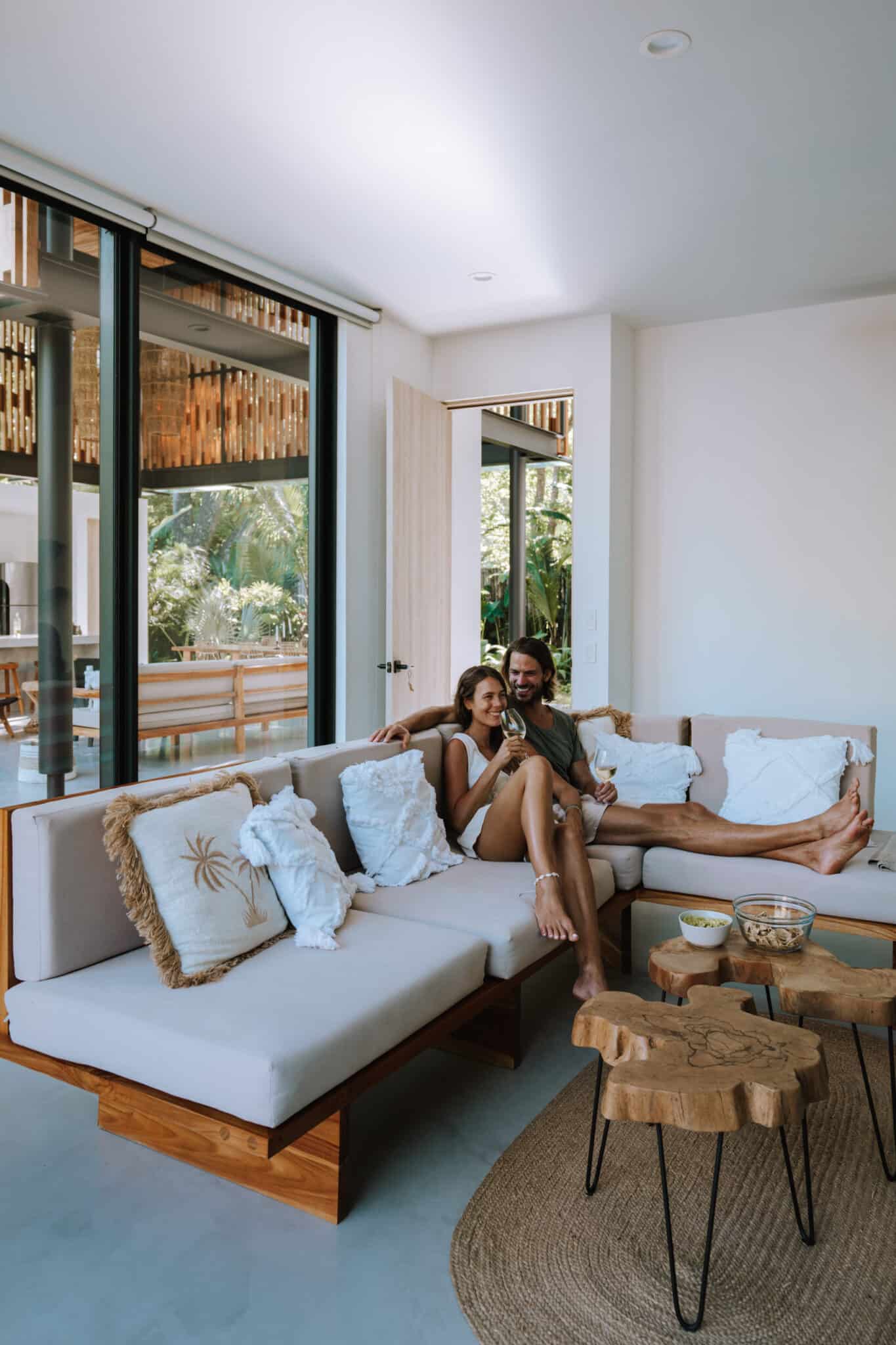 A couple collaborating on a project while lounging on a sofa in their living room.