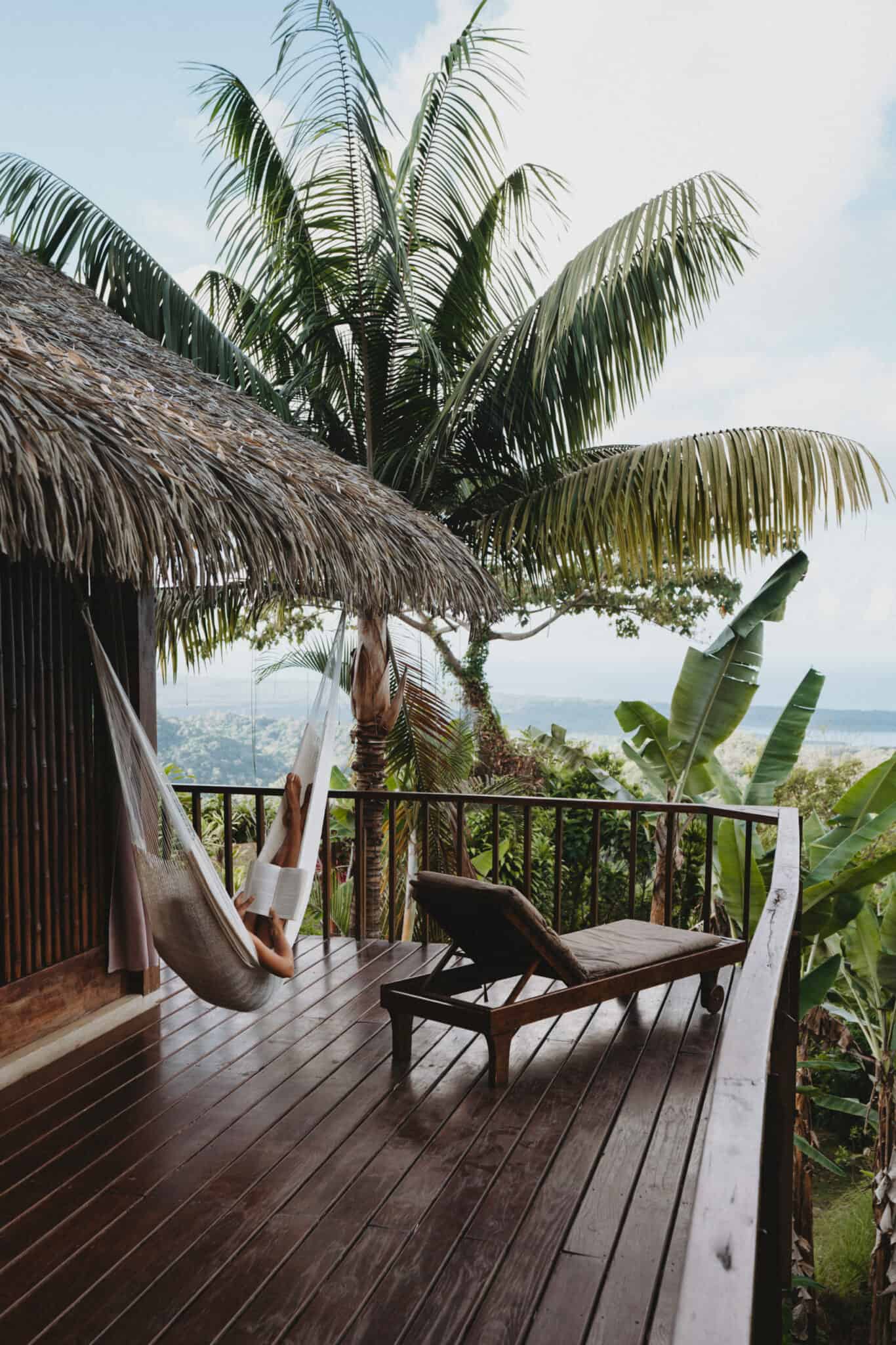 A hammock on a deck overlooking the ocean available for work with us.