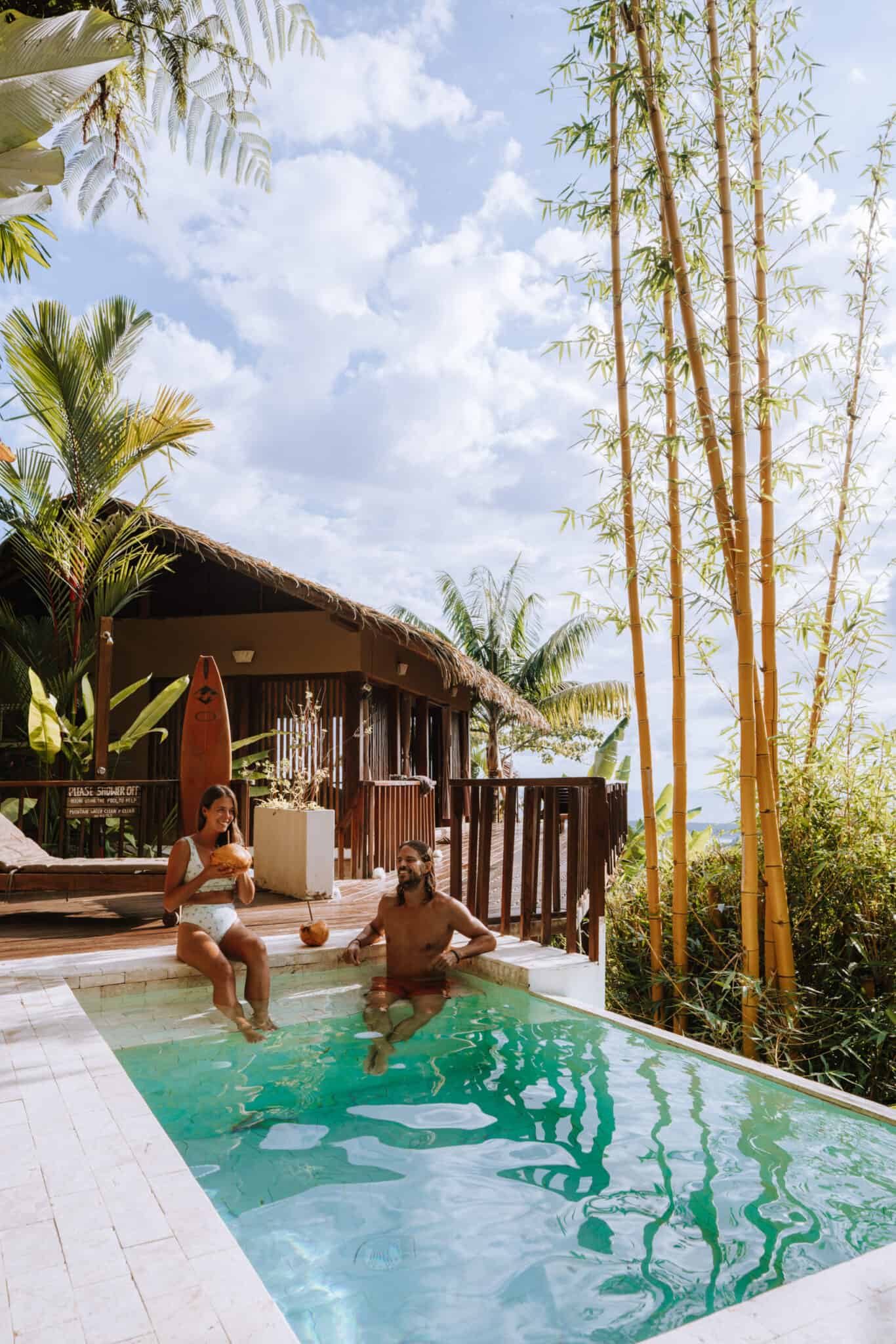 Two people sitting in a pool discussing work with us.