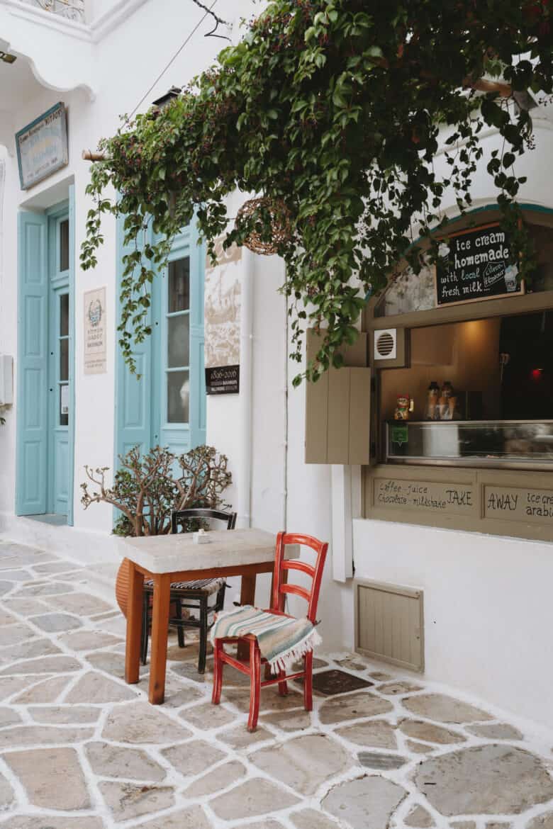 A table and chairs in front of a building on Naxos Island.