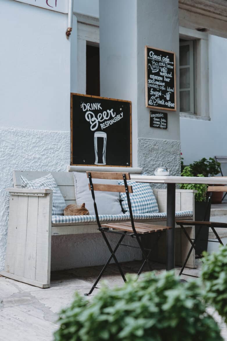 A chalkboard sign on a wooden bench in Naxos Island.