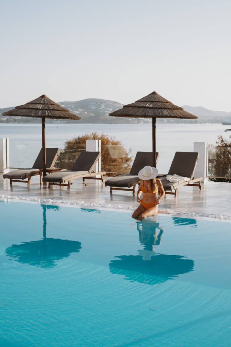 A woman is sitting in a pool in Naousa, Paros Island.