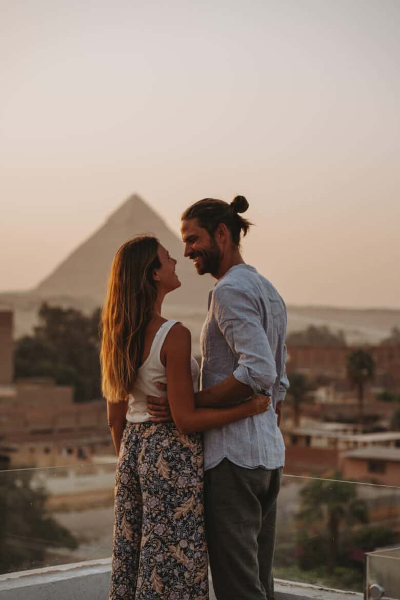 Egyptian couple embracing in front of the pyramids - egypt, couple