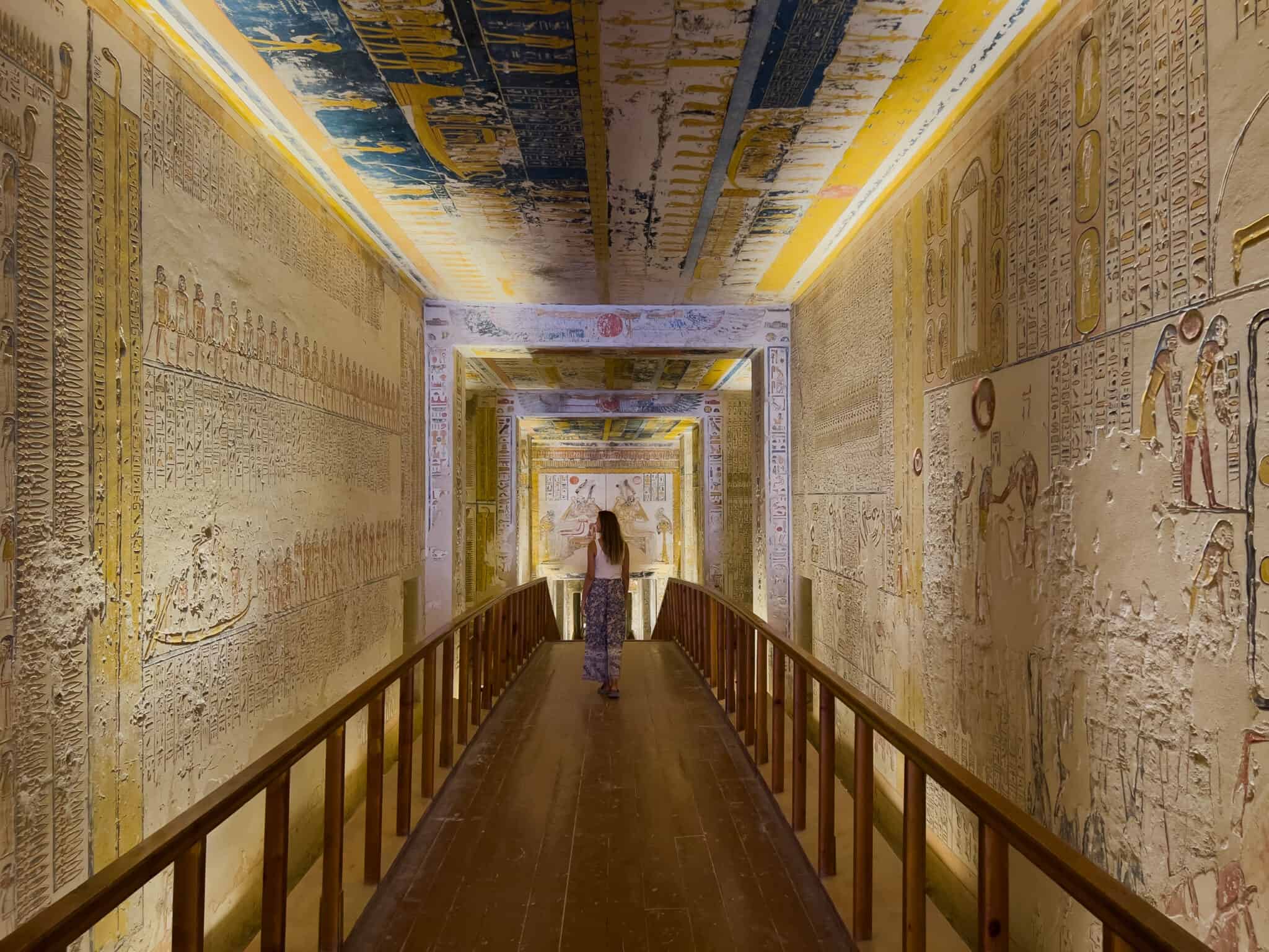 A woman is walking down a hallway in Luxor, Egypt.