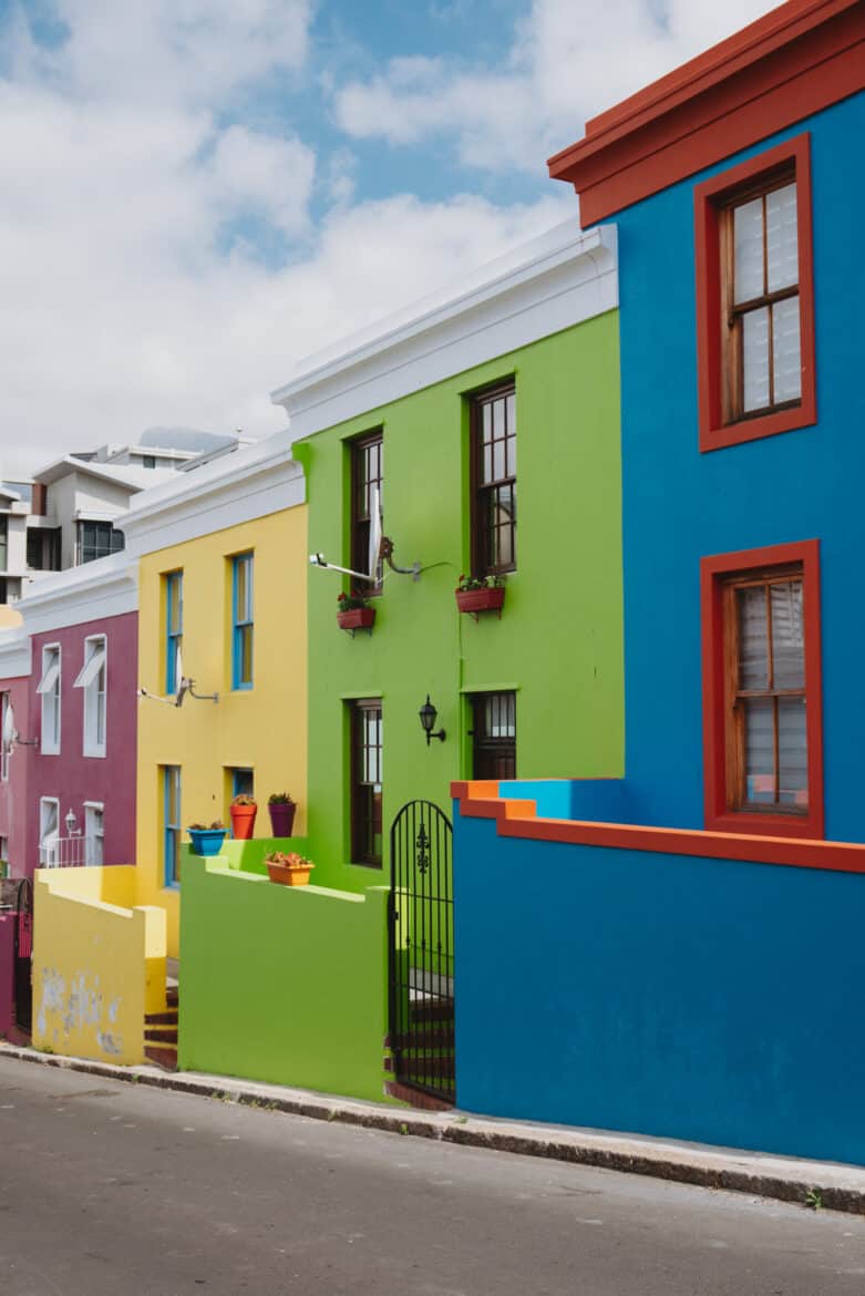 A row of colorful houses on a street in cape town.