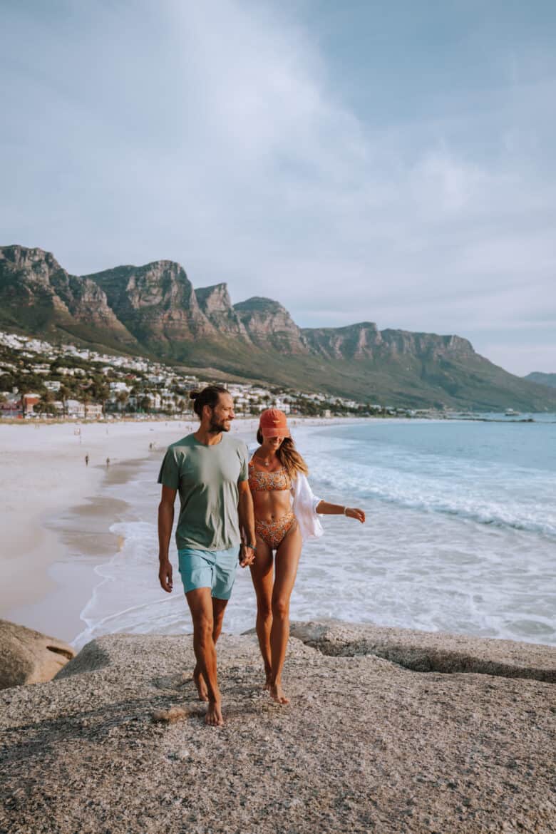 A couple walking on the beach in cape town.