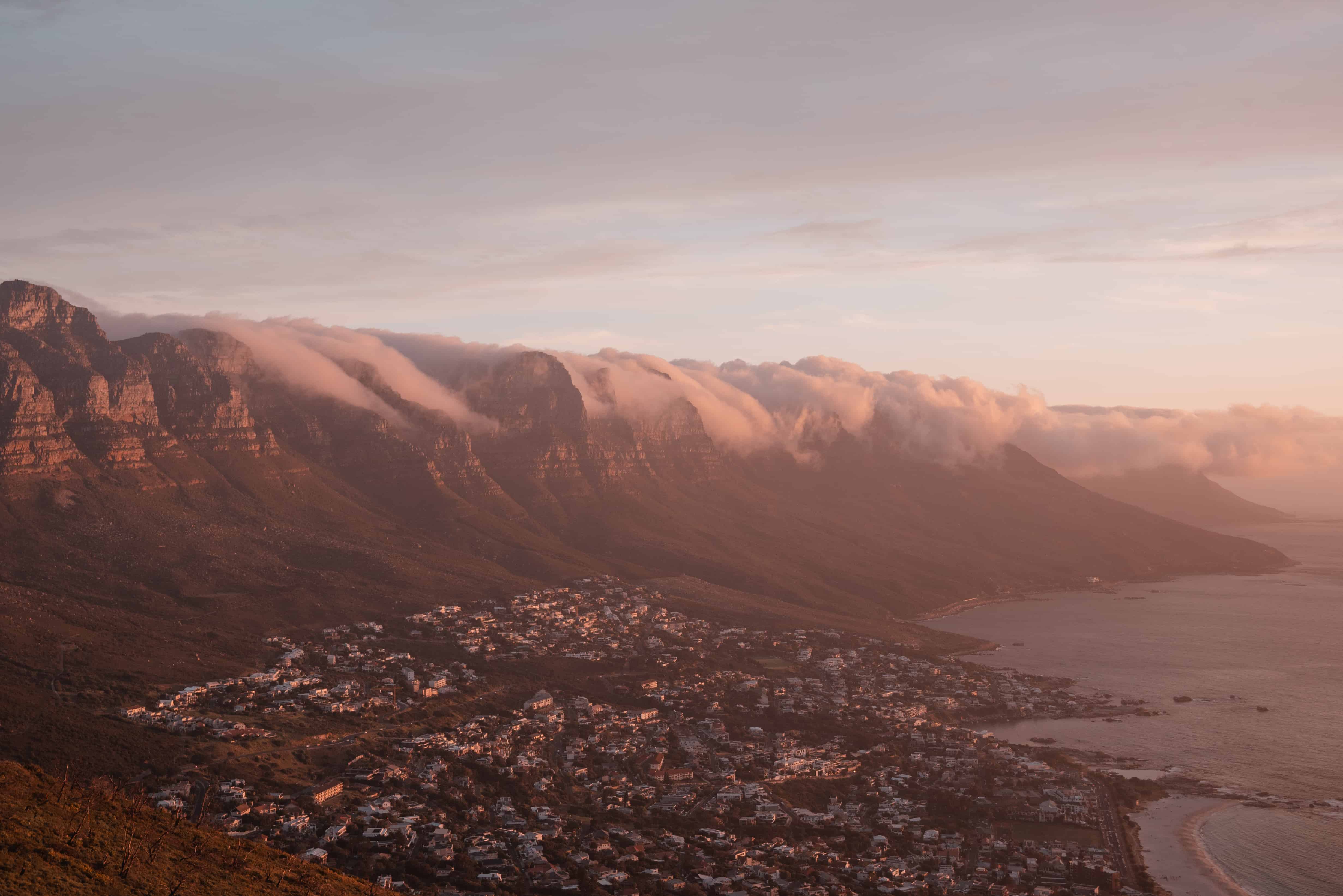 The city of cape town is seen from the top of a mountain.