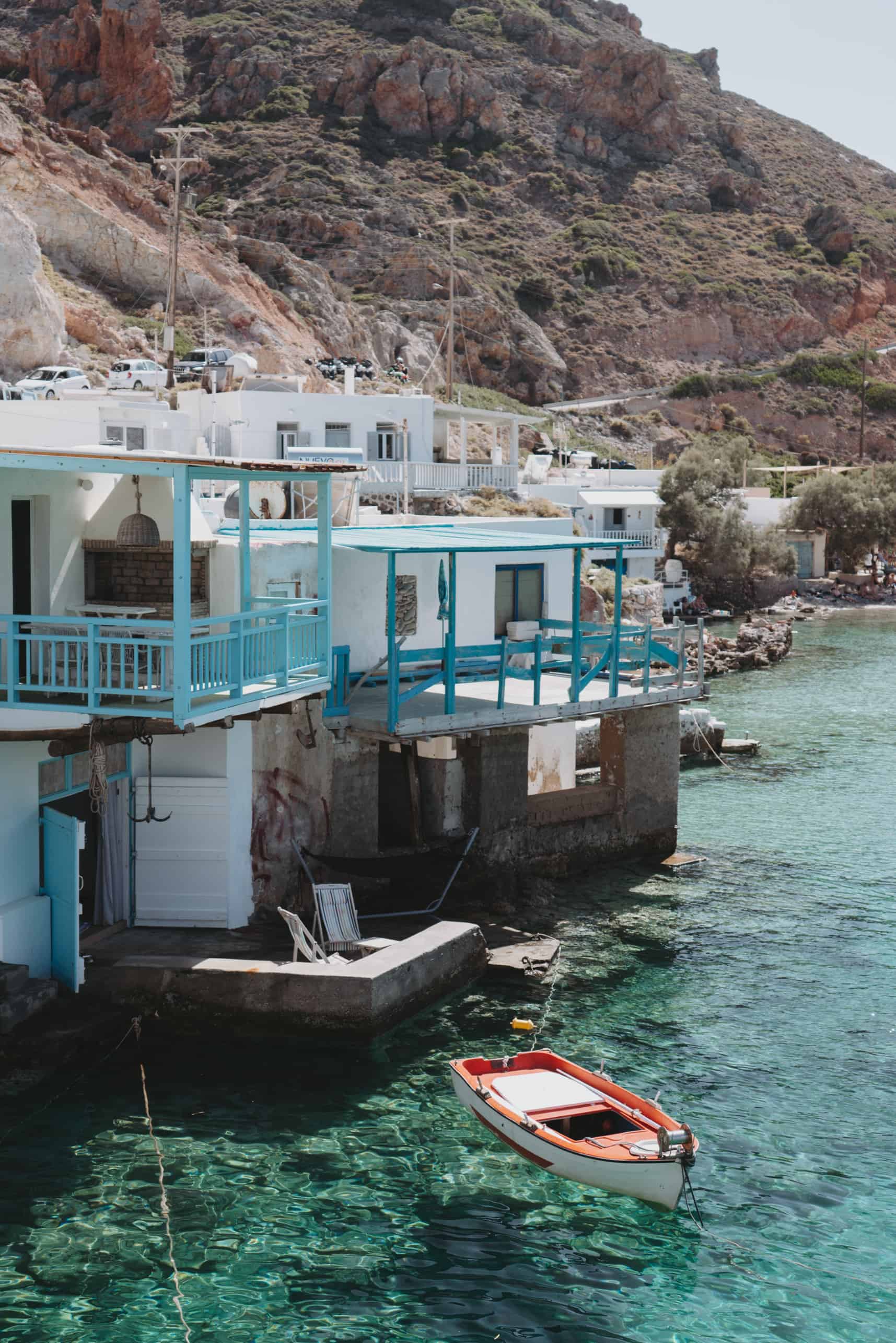 A blue boat in the waters of Milos island, Greece.