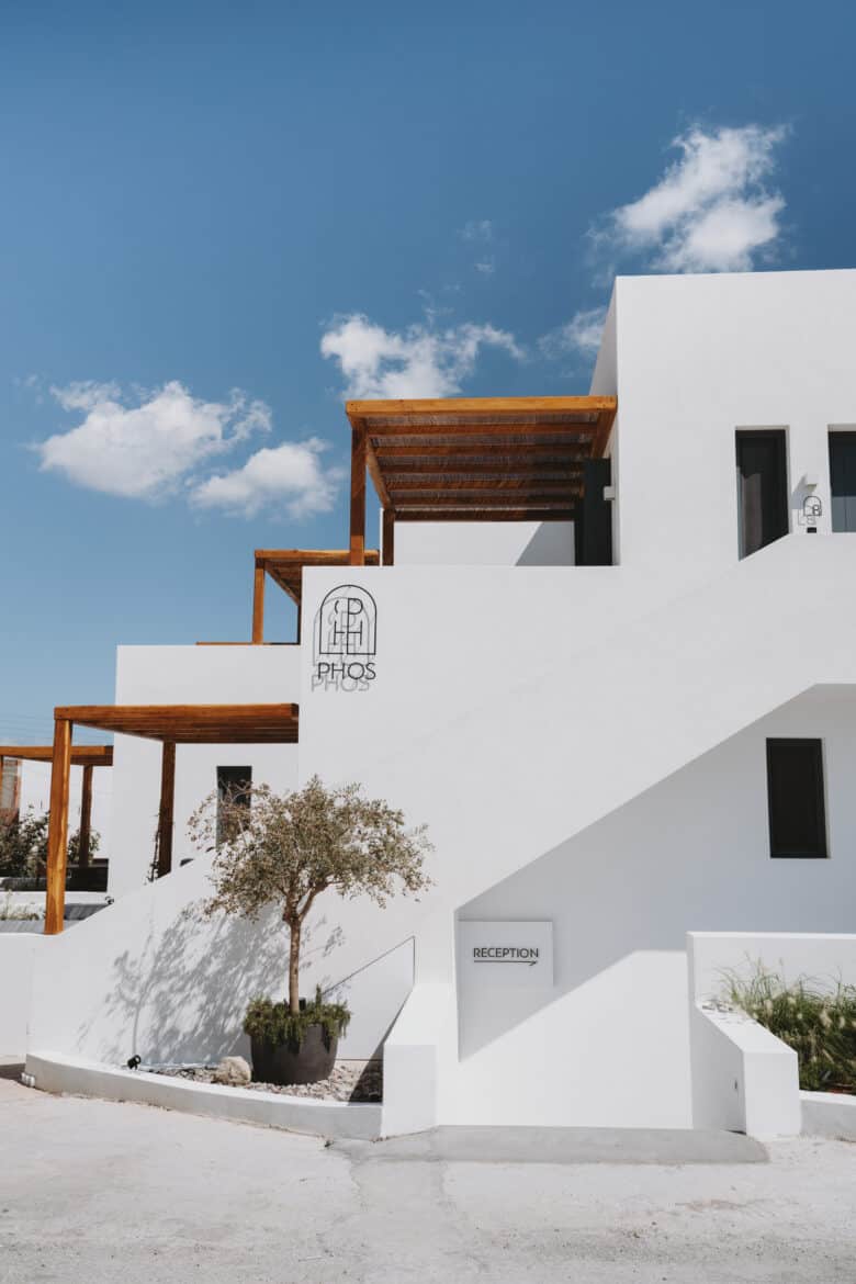 A white building with a wooden staircase on Milos island.